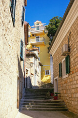 Old narrow street in Mediterranean city. View of Old Town of Herceg Novi. Montenegro