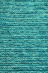 Knitting. Blue-green background, homemade knitted texture