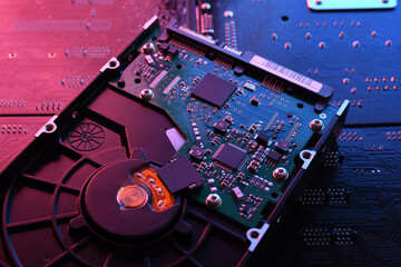 Computer Hard disk drives HDD , SSD on circuit board ,motherboard background. Close-up. With...