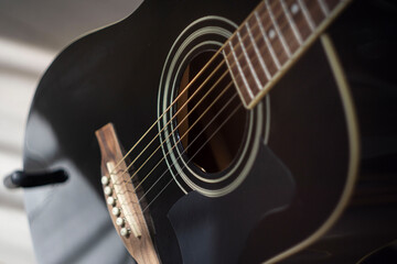 Acoustic guitar on gray background closeup