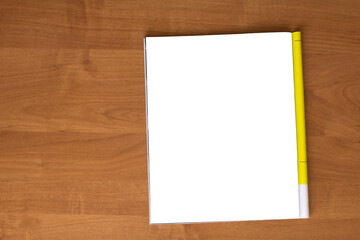 Mockup of magazine on wooden table. Blank isolated page. Top view