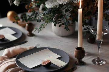 The authentic decorated wedding table with candles, flowers covered with a white tablecloth. WEDDING CONCEPT and wedding decorations. Wedding Banquet.