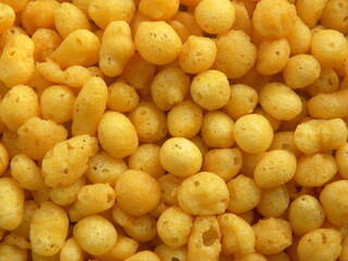 Yellow color salted fried small Boondi balls spicy Indian snack made from chickpea flour