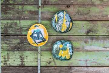 Obraz na płótnie Canvas Mid century modern wall plates with clown figures on wooden background - harlequin pattern wall hangings