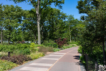 Fototapeta na wymiar Empty Green Trail at The Battery Park in Lower Manhattan of New York City during Summer
