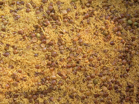 Yellow and brown color deep fried Dalmoth sev spicy Indian snack made from Masoor dal