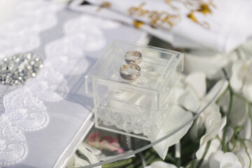 Two golden wedding rings in glass box