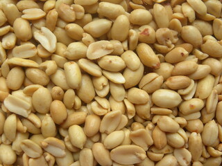 Brownish white color dry roasted and salted peanuts with skin removed