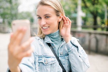 Young attractive woman using phone in city.