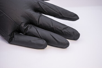 black glove on the left on a white background