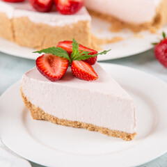 Sweet breakfast, delicious cheesecake with fresh strawberries and mint, homemade recipe without baking, on a blue stone table. Copy space.
