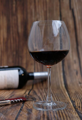 glass of red wine on wooden table