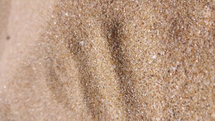 Wavy golden colored sea sand pattern background texture, close up