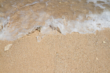 Clean fine sand beach and white wave background, nature concept, outdoor day light, summer concept background, copy space

