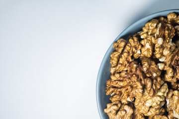 Walnuts in the bowl on the white background