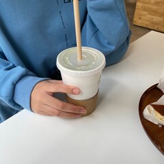 woman holding cup of coffee