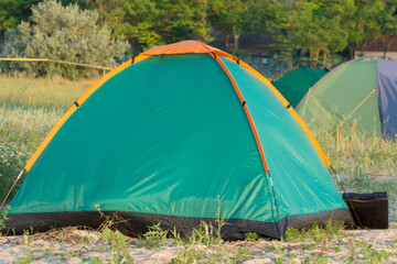Green camping tent and camp by the sea.