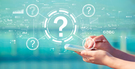 Question marks with person holding a white smartphone