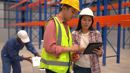 warehouse workers checking the shipment while working