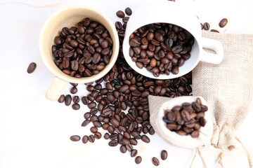 Fototapeta na wymiar Top view coffee cup and coffee beans on wooden table background and space for text 