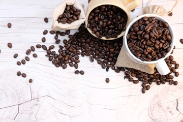 Top view coffee cup and coffee beans on wood table, space for text