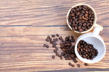 Fototapeta na wymiar coffee beans on old wood table background, space for text