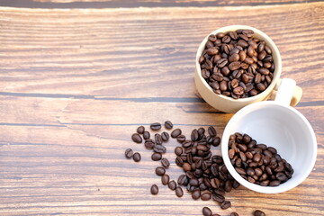 Top view coffee cup and coffee beans on wood table, space for text