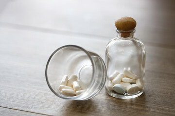 Close up medicine in abottle on wooden table. healthy and medical concept.