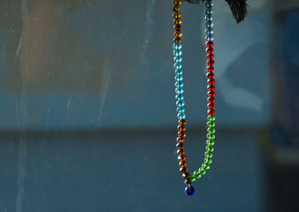 colorful rosary hanging in a car. shot at Chinchwad in Pune on 21 feb 2019.