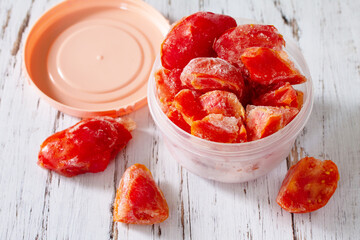 Healthy food is frozen food for the winter. Containers with frozen tomatoes.