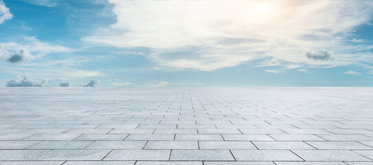 Empty square floor and blue sky with white clouds scene.