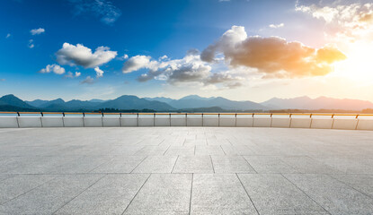 Empty square floor and mountain landscape in hangzhou at sunset.