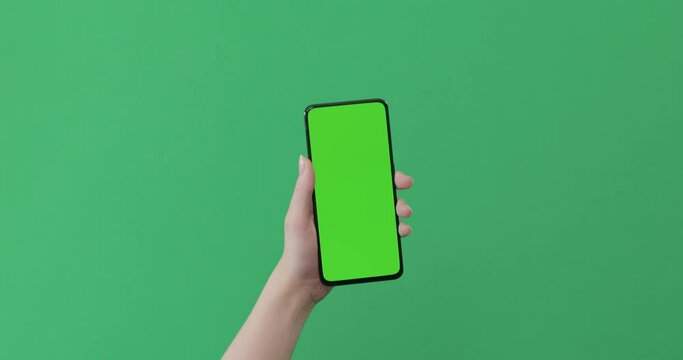 Young Female Hand Touch Smartphone With Green Screen On Green Background