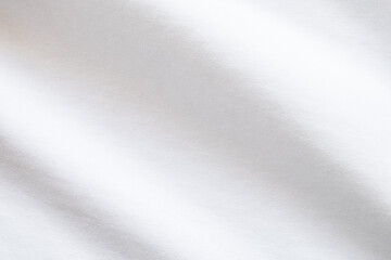 Top view close up shot of white fabric cotton shirt with woven gradient detail. Background and...