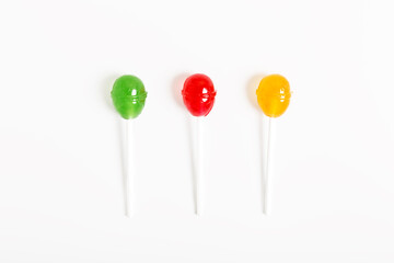 multicolored lollipops on a white background. concept of unhealthy sweets. candy concept for kids. top view, flat lay, minimalism.