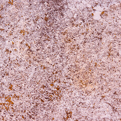 Vintage concrete background - weathered concrete surface with scratches and cracks in brown tone with remnants of light paint