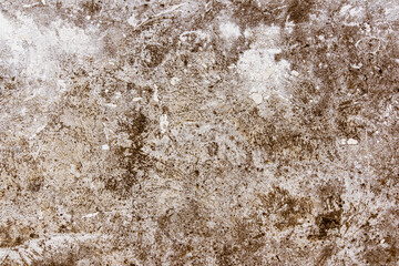 Vintage concrete background - weathered concrete surface with scratches and cracks in brown tone with remnants of light paint