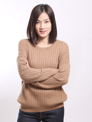 The Asian woman standing on the white background.	