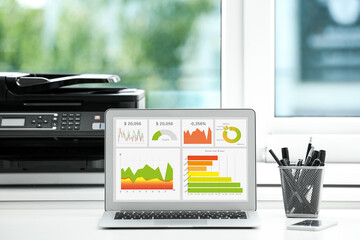 Modern laptop on desk in office. Business analytics