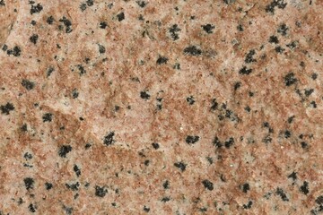 Red granite rock with black dots