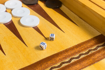 closeup of  dice on a backgammon (tawla) wooden board 