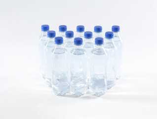 Plastic bottles with pure water on white background