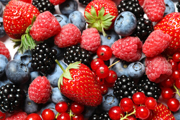 Obraz na płótnie Canvas Mix of fresh delicious berries as background, top view