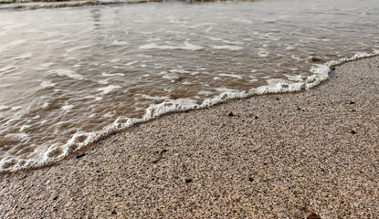Fototapeta na wymiar Water wave over the beach