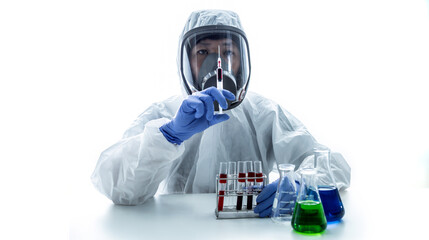 Lab technician holding syringe and blood sample inside. Scientist or doctor in personal protective equipment suit holding syringe and blood sample. Pharmaceutical and scientific research concept.