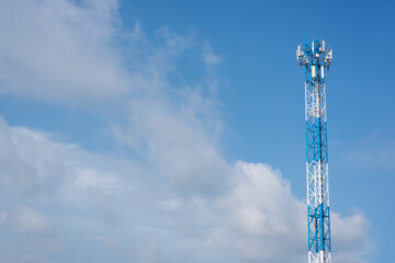 Wireless communication antenna transmitter. Telecommunication tower with blue sky.