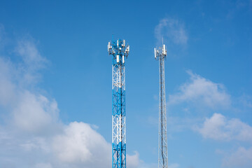 Wireless communication antenna transmitter. Telecommunication towers with blue sky.