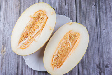 The melon is cut into two parts. Close-up of melon seeds.
