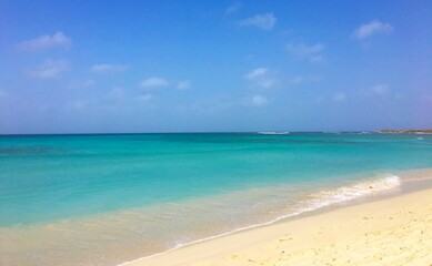 tropical beach with clear blue water and sky