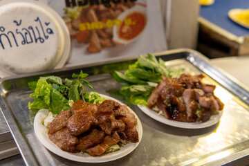 Plate of meat for sale at night Market in Northern Thailand
